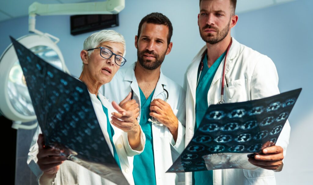 Group of radiology doctor looking at x-ray and discussing it