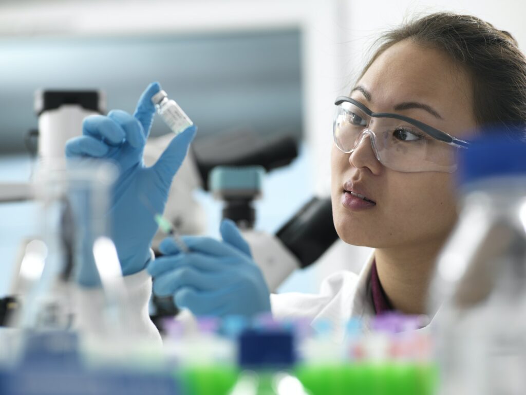 Scientist preparing new vaccine drug in laboratory for a patient
