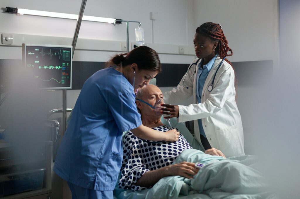 African doctor helping senior patient breath using repiratory ventilation tube