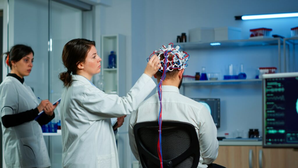 Back view of man wearing performant brainwave scanning headset