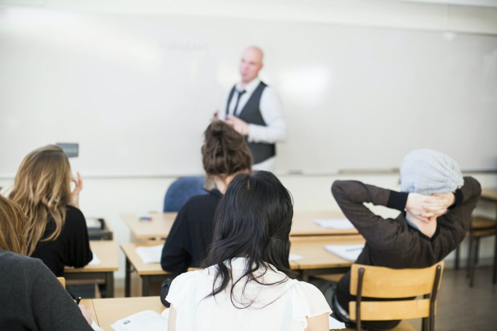 Professor teaching in classroom at high school