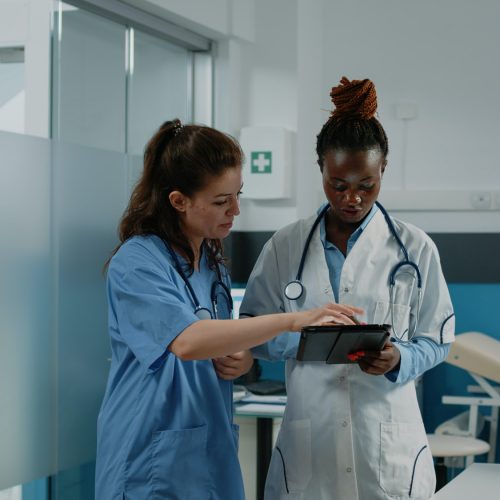 Doctor and nurse working with tablet for healthcare system
