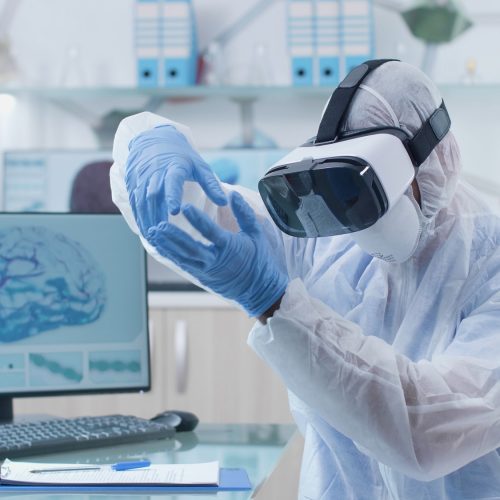 Scientist researcher doctor wearing virtual reality headset during neuroscience experiment